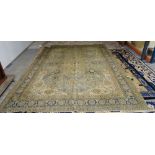A Tabriz carpet, Persian the pale indigo field with a bold saffron medallion, ivory spandrels,