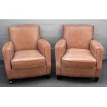 A pair of studded brown leather upholstered club armchairs, on block supports,