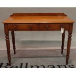 A late Victorian mahogany two drawer side table on turned supports, 105cm wide x 81cm high.