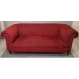 An early 20th century mahogany framed two seater sofa with roll over arms and red upholstery,