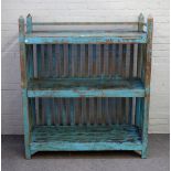 A distressed blue painted floor standing three tier shelf unit, with slatted back,