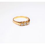 An 18ct gold and diamond set three stone ring,