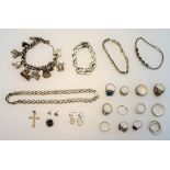 A group of mostly silver jewellery, comprising; a charm bracelet, three further bracelets,