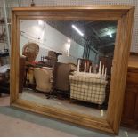 An early 20th century pine rectangular wall mirror, 180cm wide x 159cm high.