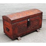 A 20th century Tudor revival studded leather veneered dome topped trunk, on sleigh feet,