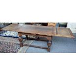 A 17th century and later oak draw leaf table, on turned supports, united by perimeter stretcher,