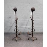 A pair of 18th century style wrought iron andirons with spherical finials and scroll adjustable