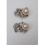 A pair of diamond and cultured pearl set earclips, each designed as a foliate scrolling spray,