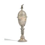 A foreign cup and cover, the stem of the cup decorated with leaves and acorns,