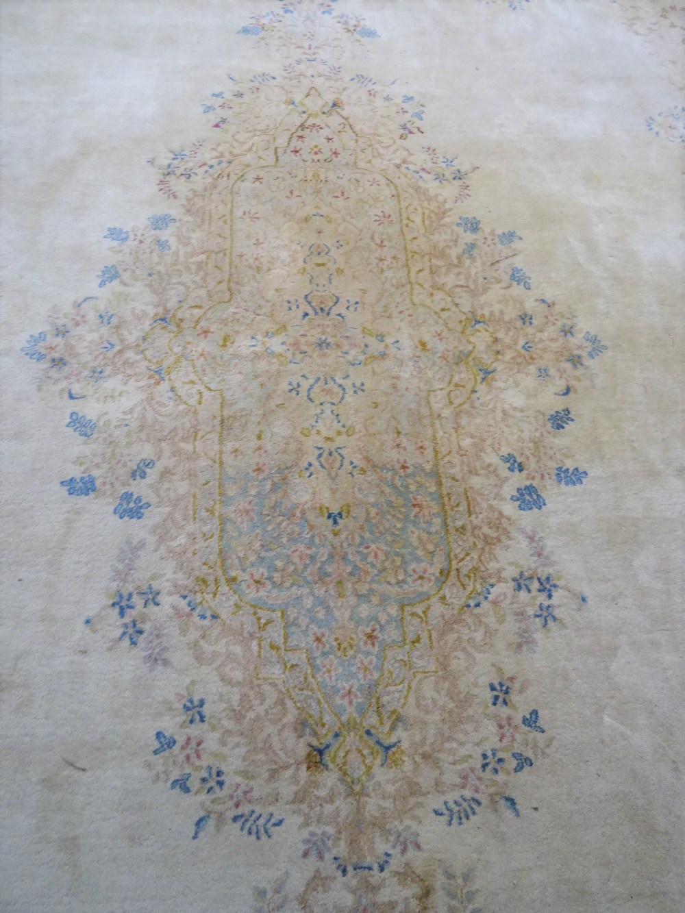 A Kerman carpet, Persian, the plain ivory field with an elongated floral medallion, - Image 11 of 11