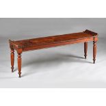 An early Victorian mahogany window seat, on turned supports, 138cm wide x 50cm high. Illustrated.