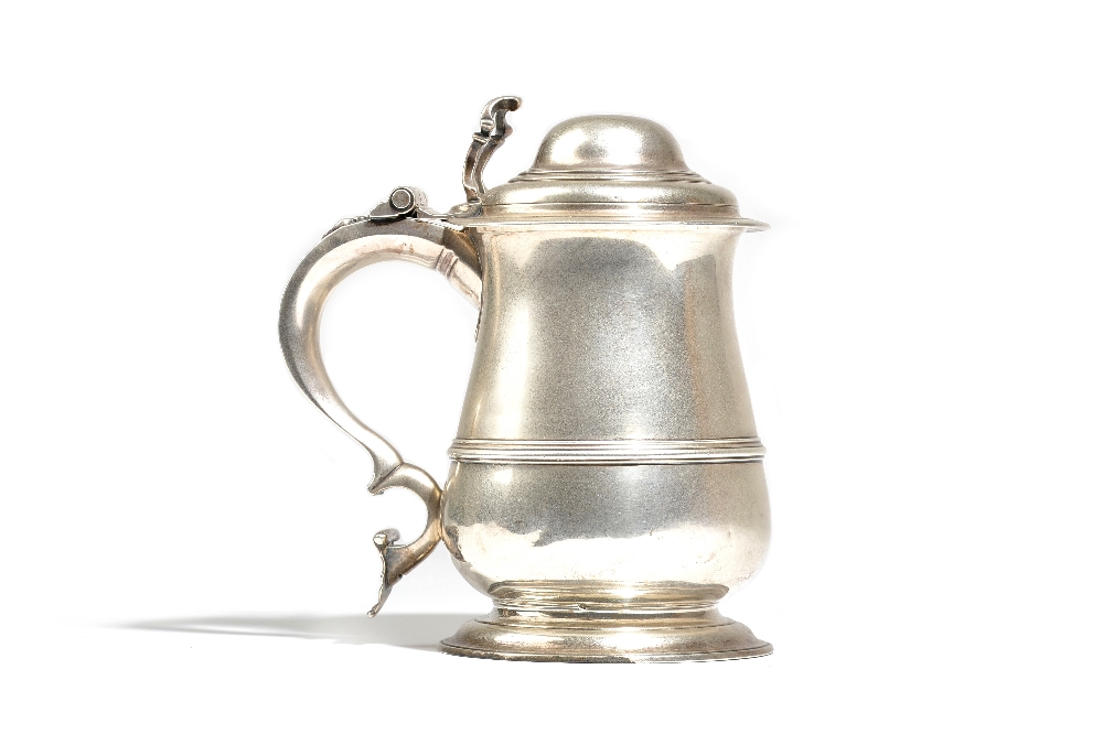 A late George II silver tankard of baluster form, the domed lid with an openwork thumbpiece,