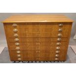 Blue Tandem Plus; a 20th century oak plan chest of nine drawers, 137cm wide x 97cm high.