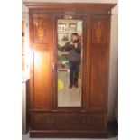 An Edwardian inlaid mahogany single wardrobe with central mirrored door over single drawer base,