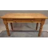 An early 20th century pine single drawer side table on turned supports, 135cm wide x 76cm high.
