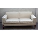 Kingscome Sofas; a modern patterned upholstered square back sofa, on tapering block supports,