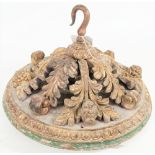 A 19th century giltwood carved ceiling rose of circular foliate domed form with a central iron hook,