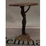 An Art Nouveau style cast iron occasional table with oak circular top on figural base,