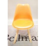 A modern orange plastic and pine dining chair, 48cm wide x 83cm high.