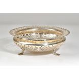 A silver shaped circular bowl, with scroll pierced decoration, within a shaped rim,