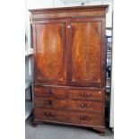 A George III linen press, the pair of inlaid oval panel doors over an associated base,