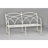 A Regency white painted wrought iron bench, with interlaced back and slatted seat,