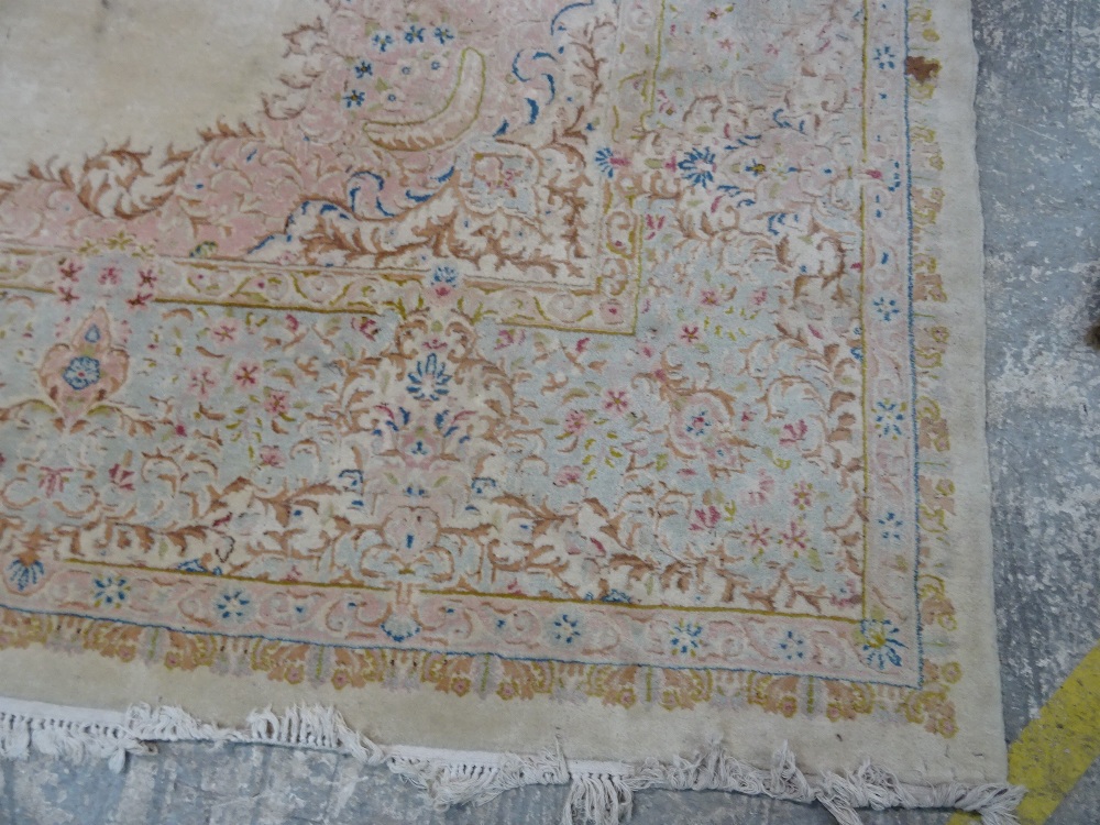 A Kerman carpet, Persian, the plain ivory field with an elongated floral medallion, - Image 2 of 11