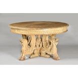 A 19th century Continental limed oak circular dining table, with carved frieze,