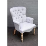 A Victorian style button back easy armchair on serpentine seat, on turned supports,
