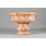 A late 19th / early 20th century veined rouge marble rounded rectangular bowl, on stepped base,