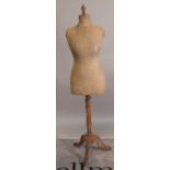 An early 20th century mannequin dummy on mahogany tripod stand, 160cm high.
