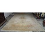 A Kerman carpet, Persian, the plain ivory field with an elongated floral medallion,