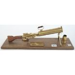 A brass model of WW I Lewis machine gun, 20th century, with brass plaque to the mahogany base,