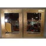 A pair of 20th century gold lacquer rectangular wall mirrors with bevelled glass,