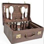 A lady's silver mounted travelling dressing/toilet set, the fittings including; a hand mirror,