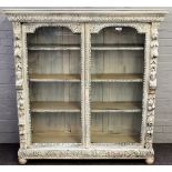 A Victorian later white painted carved oak floor standing display cabinet,