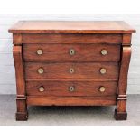 An early 19th century Continental walnut chest of four long drawers flanked by scroll mounts,