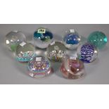 A group of nine 20th century glass paperweights, two signed to base, the largest 9cm high, (9).