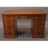 A Victorian pitch pine pedestal desk with nine drawers about the knee, 122cm wide x 59cm deep.