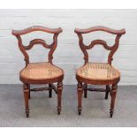 A pair of 19th century French walnut cock fighting chairs,