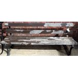 An early 20th century cast iron and hardwood slatted garden bench, 198cm wide x 74cm high.