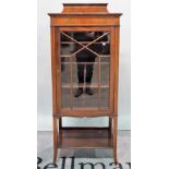 An Edwardian inlaid mahogany display cabinet, platform undertier on tapering square supports,