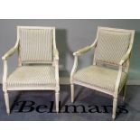 A pair of Louis XVI style white painted open armchairs on fluted supports, 57cm wide x 88cm high,