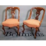 A pair of Victorian mahogany framed side chairs on cabriole supports, 50cm wide x 80cm high, (2).