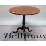 A George III mahogany tripod table on turned column and downswept supports,