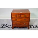 A 19th century mahogany and satinwood banded bedside chest of two short and two long drawers,