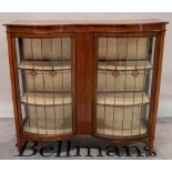 A late Edwardian mahogany serpentine display cabinet on square supports, 122cm wide x 113cm high.