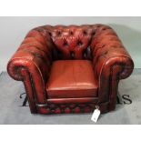 A 20th century red leather upholstered Chesterfield low armchair, 105cm wide x 75cm high.