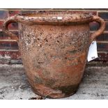 An early 20th century terracotta twin handled urn, 56cm wide x 43cm high.