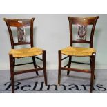 A pair of 19th century Continental walnut side chairs with rush seats, 44cm wide x 87cm high,